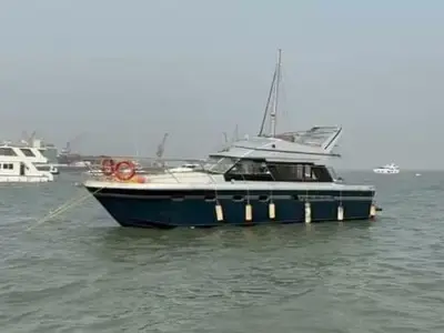 Blue Whale's dark blue hull and flybridge at anchor