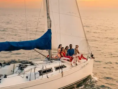 Nauti by Nature, a Hanse 33 sailing yacht in Mumbai, under sail at sunset with guests aboard