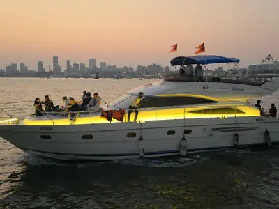 Princess 61 motor yacht Lifescapes cruising past the Mumbai skyline at dusk with guests on deck